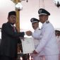 Secara simbolis Bupati Sumenep H. Achmad Fauzi Wongsojudo menyerahkan SK perpanjangan masa jabatan kepada kepala desa, Kamis 27/6/2024 (Foto: istimewa) 