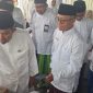 Dirut BPRS Bhakti Sumekar Hairil Fajar bersama Bupati Fauzi mengenakan pakaian layaknya santri (foto: ist) 